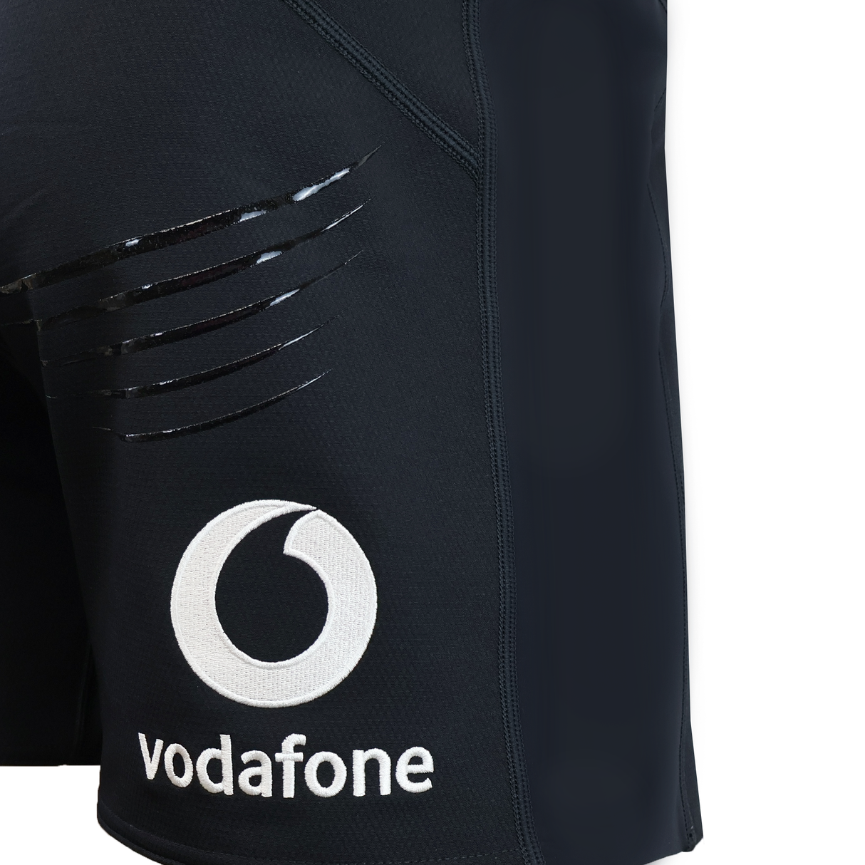Close-up of the Ireland 25/26 Training Short by Canterbury in black, showing glossy claw mark designs and a white Vodafone logo with text on the left leg.