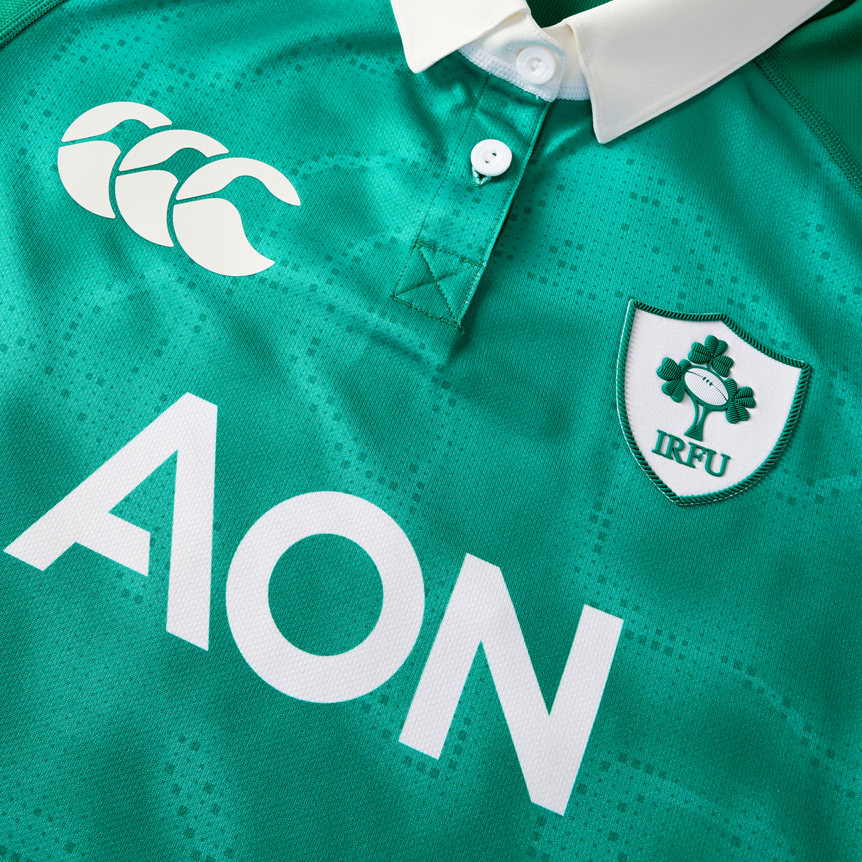 The Women's Ireland WIRFU 25/26 Pro Home Jersey by Canterbury features a white collar, CCC logo, AON sponsor, and IRFU shamrock crest—ideal for fans seeking the official women's home rugby jersey.