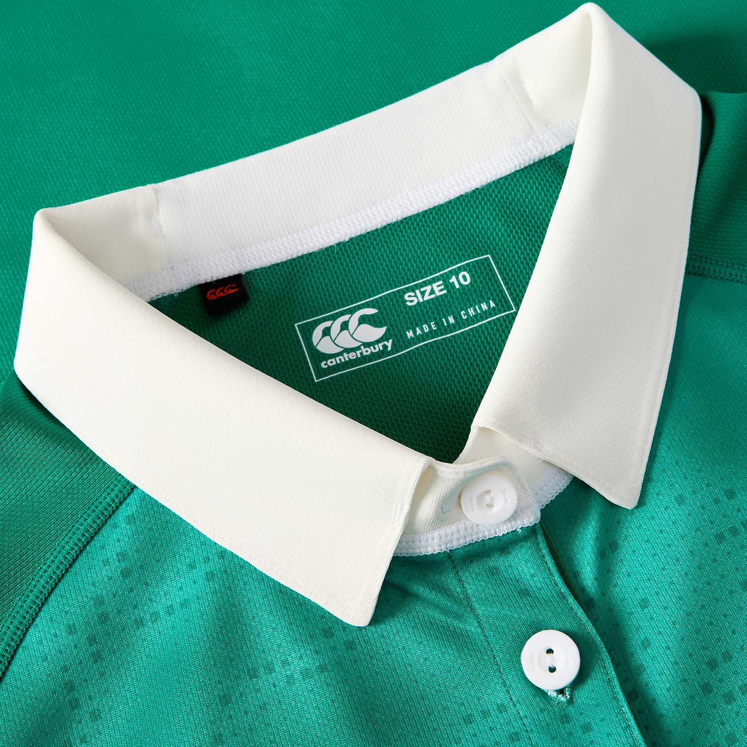 Close-up of the Women's Ireland 25/26 Home Pro Jersey by Canterbury, showing a white collar, two white buttons, and a size 10 label with "made in China.