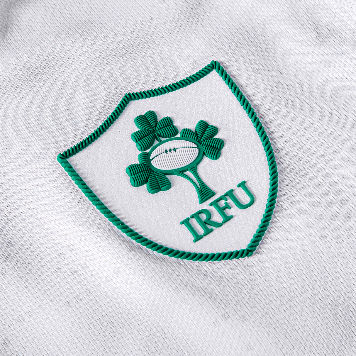 The Women's Ireland 25/26 Alternate Pro Jersey by Canterbury features the IRFU logo with three green shamrocks and a rugby ball in a green-bordered shield—a classic white Ireland rugby jersey.
