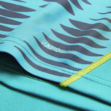 Close-up of the Ireland 26 Pre Game Pro Jersey by Canterbury, featuring a turquoise moisture-wicking fabric with wavy black stripes and visible stitching. The word “VAPODRI” is printed in white on the surface, highlighting the advanced technology that sets Canterbury jerseys apart.