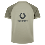 The Ireland 25/26 Autumn Internationals Pro Training Jersey by Canterbury is a khaki short-sleeve raglan shirt styled like an Ireland rugby jersey, featuring the Vodafone logo and text on the back.