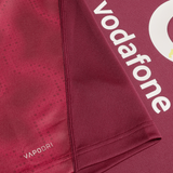 Close-up of the maroon Ireland 25/26 Autumn Internationals Pro Training Jersey by Canterbury, showing white "vodafone" and "VAPODRI" text, with detailed focus on seam and fabric texture.