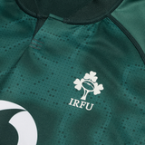 Close-up of the Ireland 25/26 Six Nations Pro Training Jersey by Canterbury, showcasing the IRFU shamrock and rugby ball logo, crafted with advanced Vapodri technology for peak performance.
