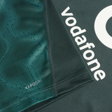 Close-up of the dark green Ireland 25/26 Six Nations Pro Training Jersey by Canterbury, highlighting "vodafone" branding, "VAPODRI" text near a seam, and advanced Vapodri technology for superior comfort.
