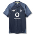 The Ireland 26 Training Pro Jersey by Canterbury is a navy blue rugby top with short sleeves, Vodafone sponsor, and IRFU chest logo, featuring patterned shoulder panels. Displayed on a white background, this Canterbury jersey is crafted with innovative VapoDri fabric for superior comfort and performance.