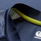 Close-up of a dark blue Ireland 26 Training Pro Jersey by Canterbury featuring textured VapoDri fabric, yellow inner collar detailing, and Canterbury brand logo and tag.