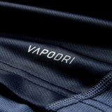 Close-up of dark blue athletic fabric from the Ireland 26 Training Pro Jersey by Canterbury, featuring the word “VAPODRI” printed in white and visible stitching along the edges.