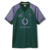 The Ireland 26 Training Pro Jersey by Canterbury features green and purple colors, the Vodafone logo, Canterbury branding, and the IRFU emblem. Crafted from VapoDri fabric for optimum performance, this Canterbury training jersey is showcased against a white background.