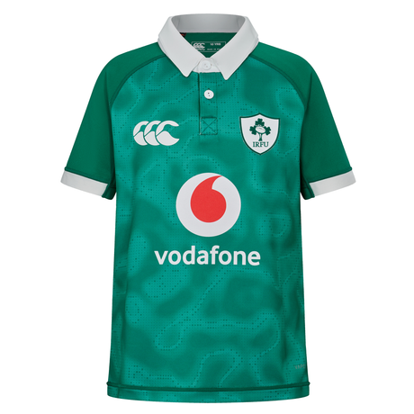 The Youth Ireland 25/26 Home Pro Jersey by Canterbury is a green, short-sleeve rugby top with a white collar and cuffs, featuring Canterbury, Vodafone, and IRFU logos on the front.