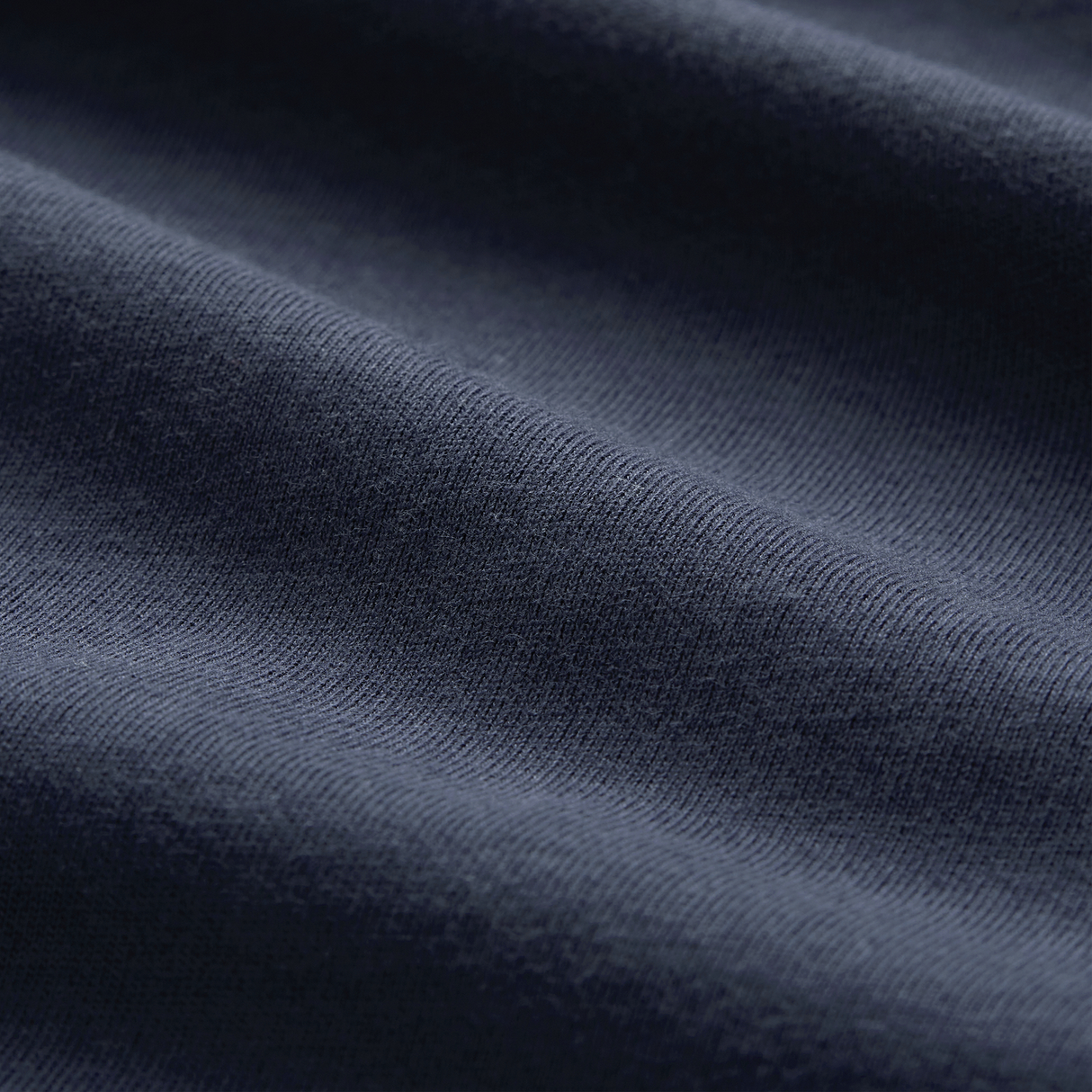 Close-up of dark blue Canterbury fabric with visible texture and soft folds—ideal for the Ireland 26/27 Summer Tour Team Cotton T-Shirt by Canterbury.