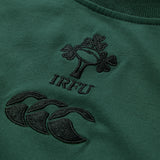Close-up of a green fabric with embroidered IRFU and Canterbury logos in black thread, highlighting the quality of the Ireland 26 Team Cotton T-shirt by Canterbury.