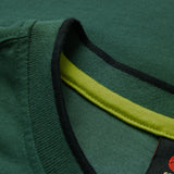 Close-up of the Ireland 26 Team Cotton T-shirt by Canterbury, showing a green collar with a black outer edge and a yellow inner seam detail, inspired by the iconic Canterbury Ireland shirt.