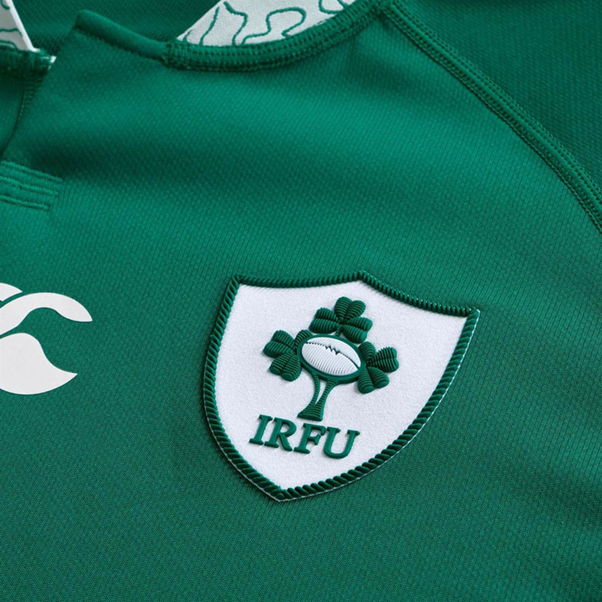 Close-up of the Ireland WRWC25 Replica Home Jersey by Canterbury, showcasing the IRFU crest and a white Canterbury logo.