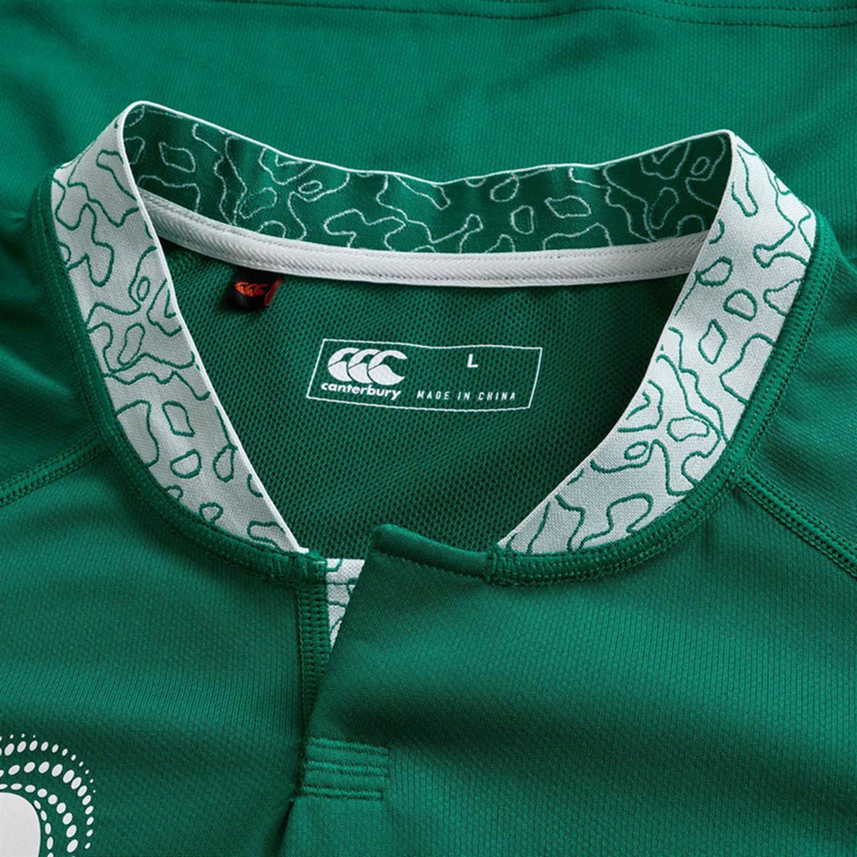 Close-up of the Ireland WRWC25 Replica Home Jersey by Canterbury, featuring a green design, patterned collar, Canterbury logo, and visible size label "L" inside.