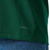 Close-up of the lower part of the Canterbury Ireland WRWC25 Replica Home Jersey in green with "VAPODRI" printed on it, paired with blue denim jeans.