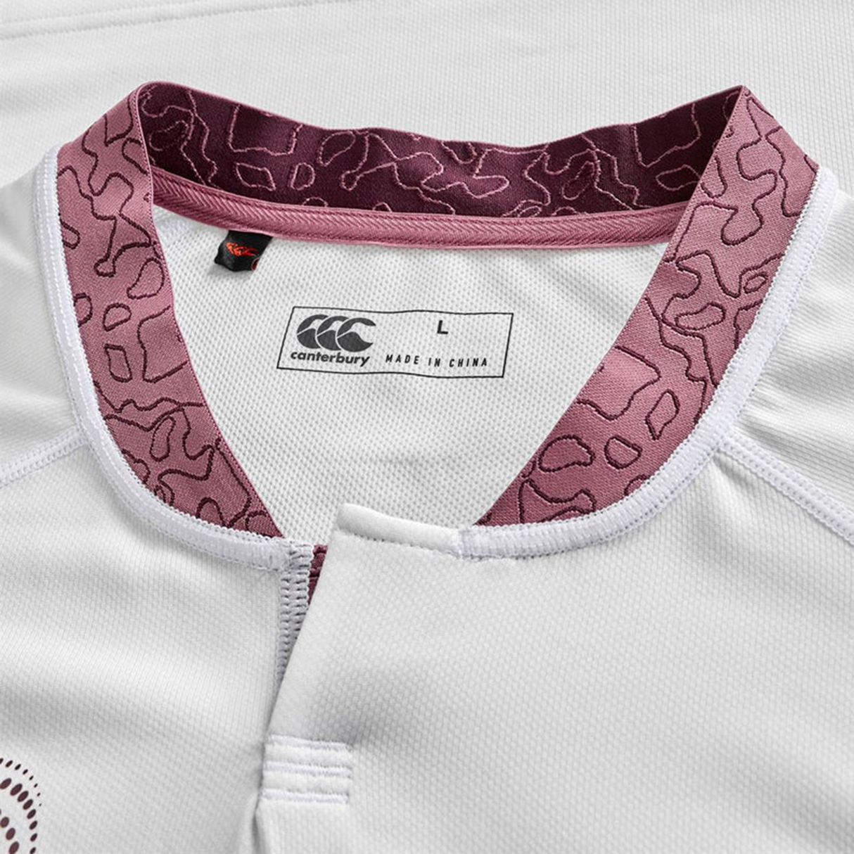 Close-up of the Ireland WRWC25 Replica Alternate Jersey by Canterbury, showing a maroon patterned collar, brand tag, and size label marked "L, made in China.
