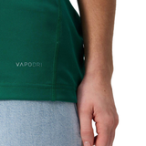 Close-up of a person wearing the Canterbury Women's Ireland WRWC25 Replica Home Jersey with light blue jeans, hand resting at their side.