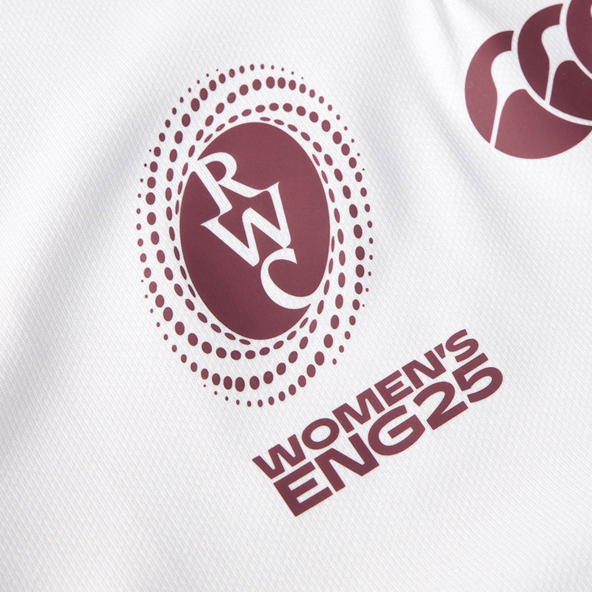 Close-up of a white Canterbury Women's Ireland WRWC25 Replica Alternate Jersey showing the RWC logo and "Women's IRE25" in maroon lettering.