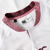 Close-up of the Women's Ireland WRWC25 Replica Alternate Jersey by Canterbury, white with a maroon patterned collar, featuring a "SIZE 10" and "MADE IN CHINA" brand tag.
