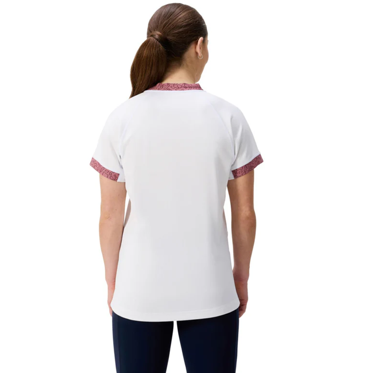 A person with brown hair in a ponytail is shown from the back wearing the Canterbury Women's Ireland WRWC25 Replica Alternate Jersey and dark pants.