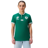A person wearing the Women's Ireland WRWC25 Classic Jersey by Canterbury with chest logos and light blue jeans stands facing forward against a white background.