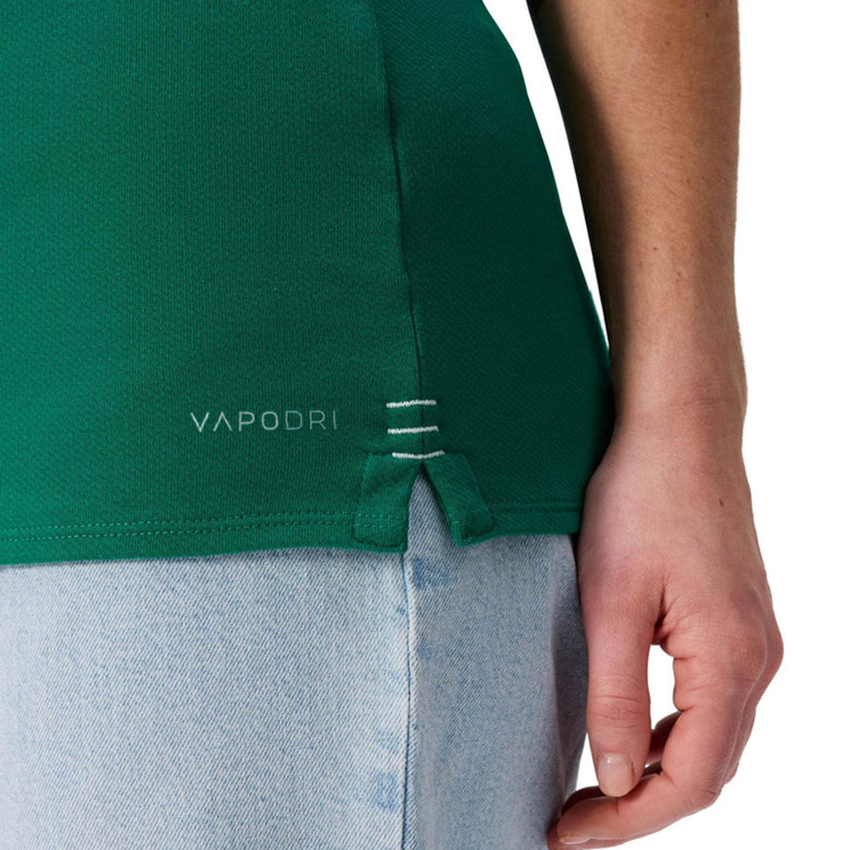 A woman wearing the Women's Ireland WRWC25 Classic Jersey by Canterbury, featuring "VAPODRI" branding, and light blue jeans is shown from the side with her hand by her hip.
