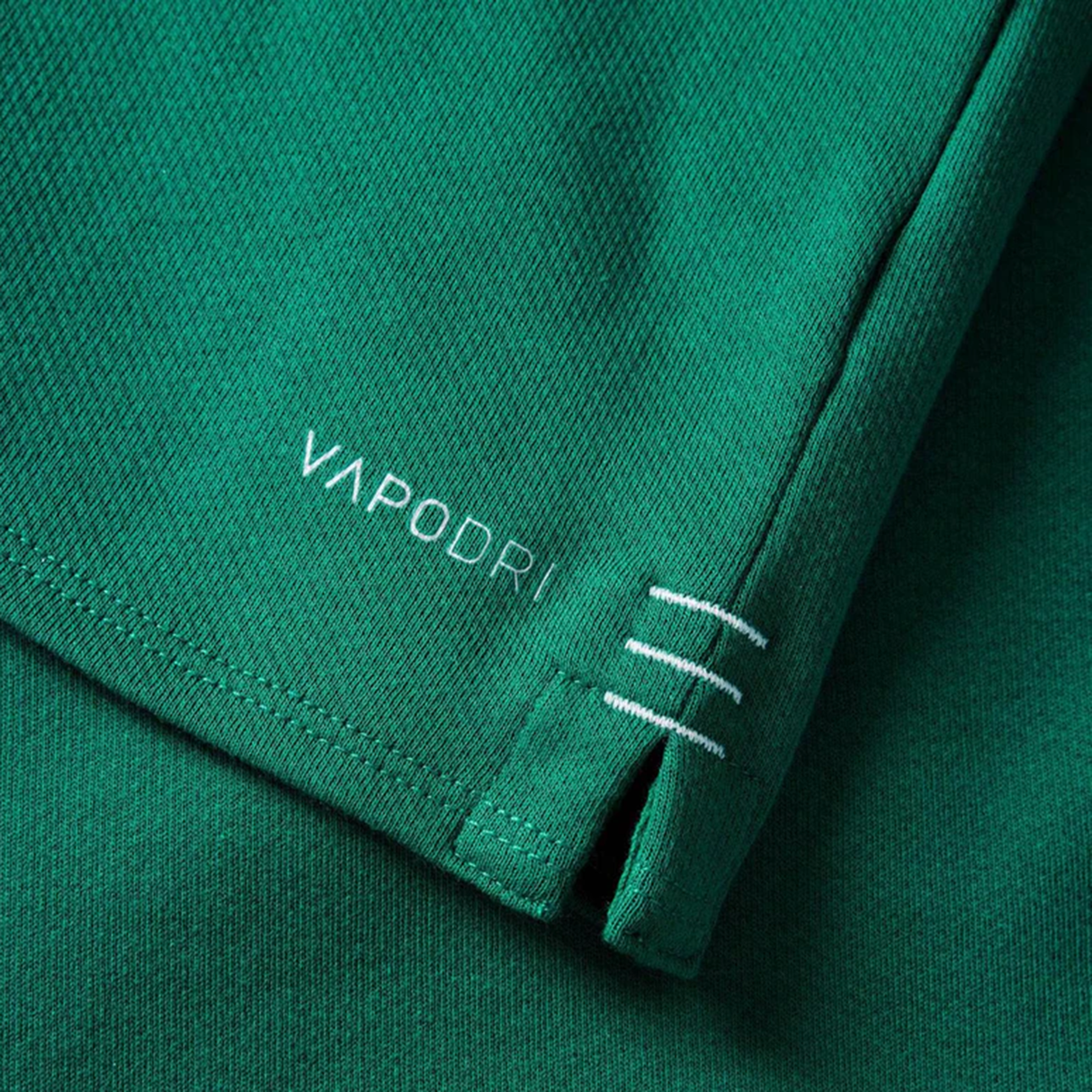Close-up of the Women's Ireland WRWC25 Classic Jersey by Canterbury, showing "VAPODRI" near the hem and three white stitched lines above a small side slit.