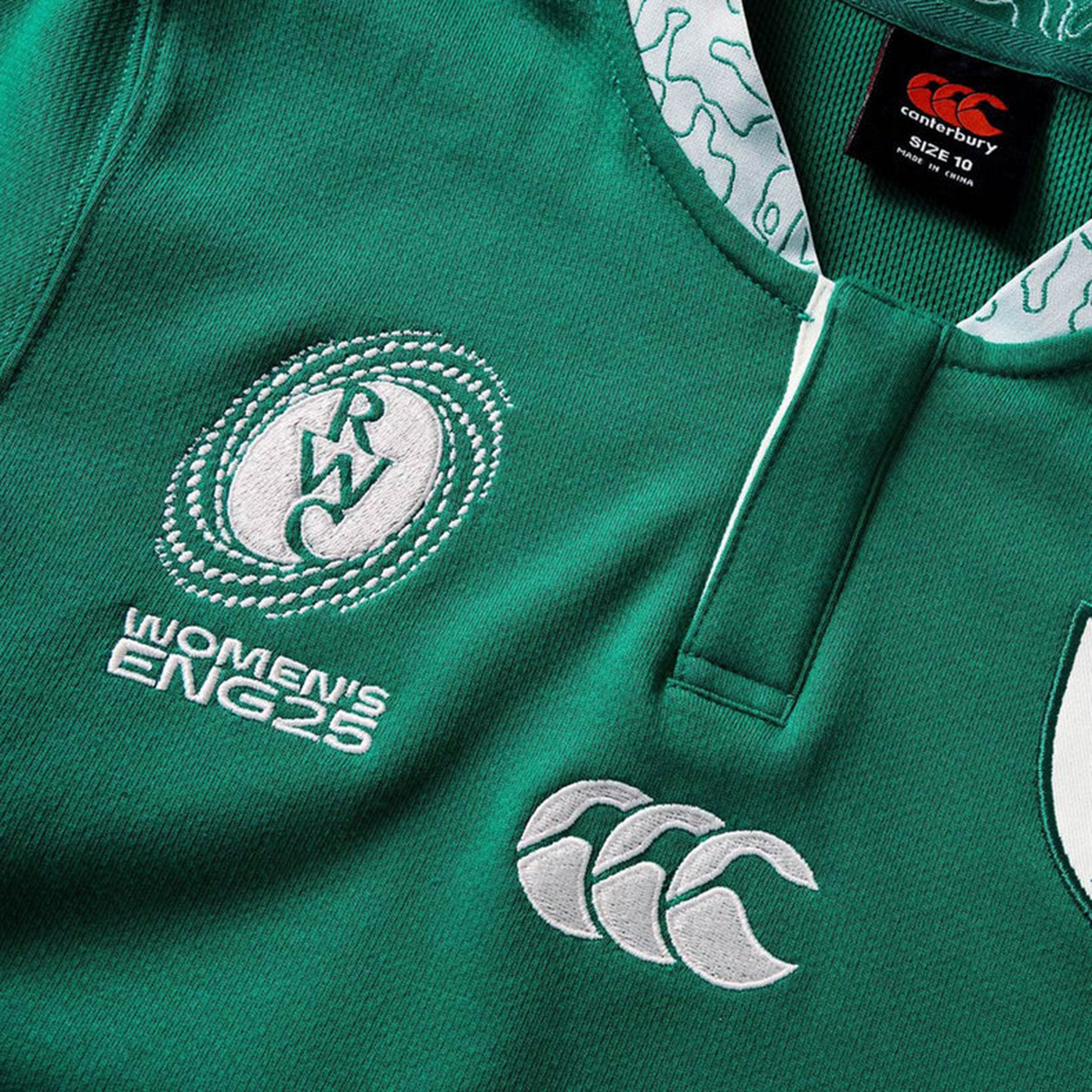 Close-up of the Women's Ireland WRWC25 Classic Jersey by Canterbury, featuring "RWC Women's ENG25," the Canterbury logo, and a detailed collar with white patterns—perfect for fans of Ireland's women's rugby.