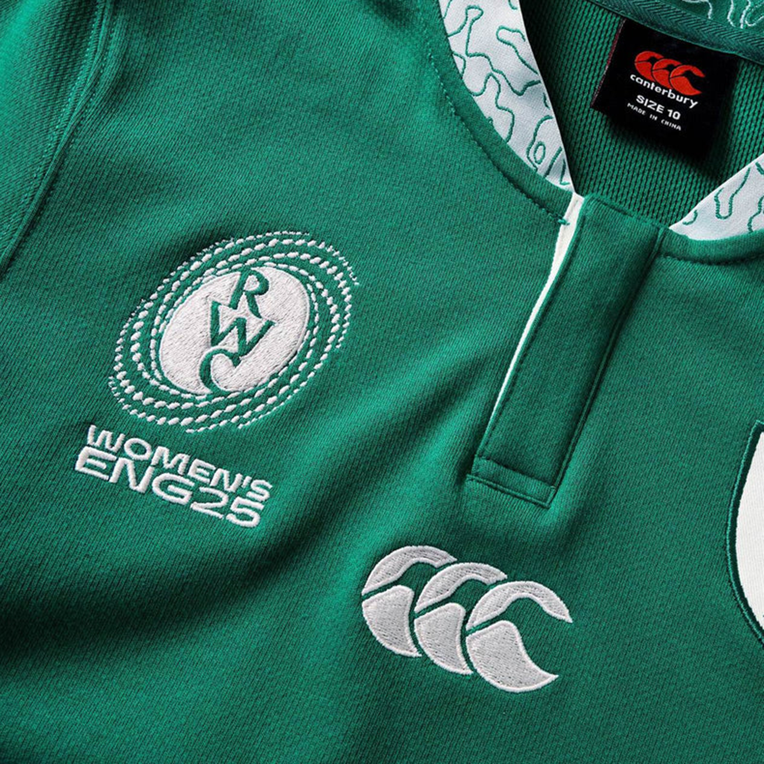 Close-up of the Women's Ireland WRWC25 Classic Jersey by Canterbury, featuring "RWC Women's ENG25," the Canterbury logo, and a detailed collar with white patterns—perfect for fans of Ireland's women's rugby.