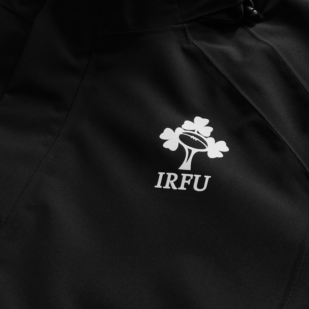 The Canterbury Ireland 25/26 Water Resistant Insulated Jacket features the IRFU logo in white, displaying a rugby ball inside a shamrock—ideal for rugby fans seeking comfort, style, and protection from the elements.
