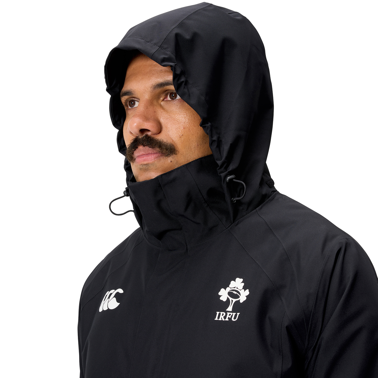 Man in an Ireland 25/26 Water Resistant Insulated Jacket by Canterbury, looking to the side against a plain background.