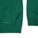 Close-up of the Youth Ireland 25/26 Anthem Track Jacket by Canterbury in green, showing elastic cuffs, a zippered pocket, and "VAPOSHIELD" printed near the pocket.