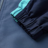 Close-up of the cuff and sleeve of the Ireland 26 Legends 1/4 Zip Jacket by Canterbury in navy blue with a teal stripe, highlighting the elastic material and part of the zipper.