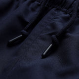 Close-up of dark blue fabric with an elastic waistband and two black drawstrings featuring plastic tips, highlighting the detail found in the Ireland 26 Legends 32″ Trackpant by Canterbury.
