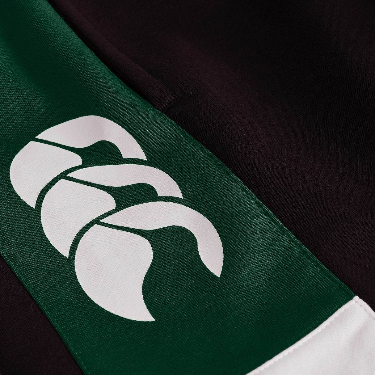 Close-up of the green and black Ireland Legends 7" Shorts by Canterbury, featuring a white Canterbury logo with three claw-like shapes.