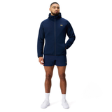 A man faces forward wearing a navy blue Canterbury Everest Full Zip Hoodie and matching shorts, paired with white socks and sneakers, set against a plain white background.