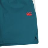 Close-up of the lower part of Canterbury Tempo+Woven 5" Shorts in teal, featuring a red Canterbury logo on the side.