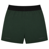 The Canterbury Everest Woven Short 5" in dark green has a black elastic waistband, subtle seam details, and two small reflective strips near the hem. Made from four-way stretch fabric, it's designed for optimal comfort during performance training.