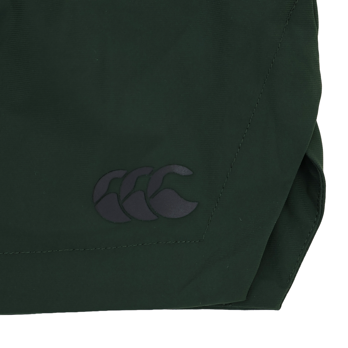 Close-up of a dark green four-way stretch fabric used in the Canterbury Everest Woven Short 5", featuring a black Canterbury logo with three overlapping curved shapes.