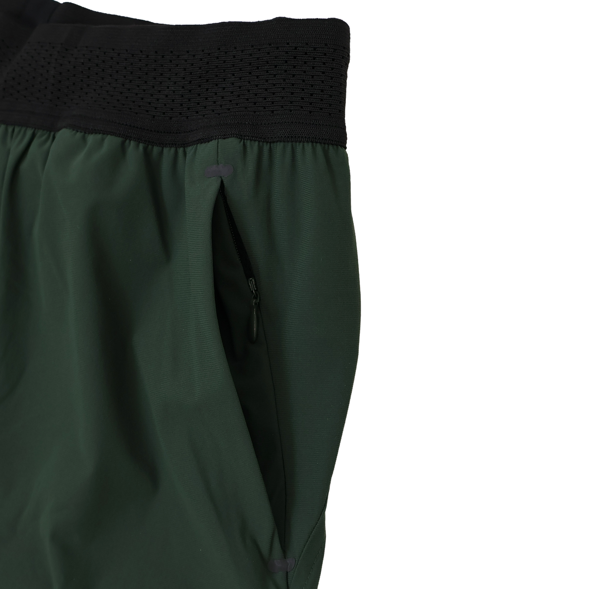 Close-up of the Canterbury Everest Woven Short 5" by Canterbury, a green training short with black elastic waistband, zippered side pocket, and four-way stretch fabric for optimal comfort.
