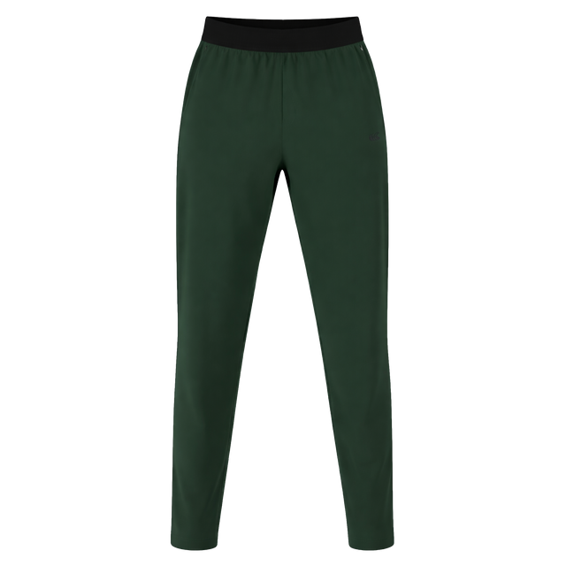 The Canterbury Everest Woven Pant 30" in dark green features a black elastic waistband, sweat-wicking fabric, and four-way stretch for comfort, shown on a white background.