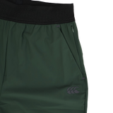 Close-up of the Canterbury Everest Woven Pant 30" by Canterbury, featuring a black waistband, zippered pocket, small logo on the lower leg, and crafted from four-way stretch fabric for comfort and flexibility.
