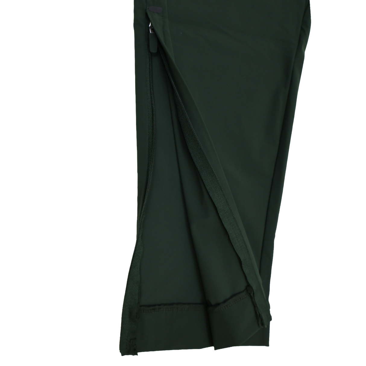 Close-up of the Canterbury Everest Woven Pant 30" leg in dark green, showing a partially unzipped seam with visible inner fabric and stitching. This pant features sweat-wicking comfort and four-way stretch for easy movement.
