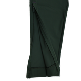 Close-up of the Canterbury Everest Woven Pant 30" leg in dark green, showing a partially unzipped seam with visible inner fabric and stitching. This pant features sweat-wicking comfort and four-way stretch for easy movement.