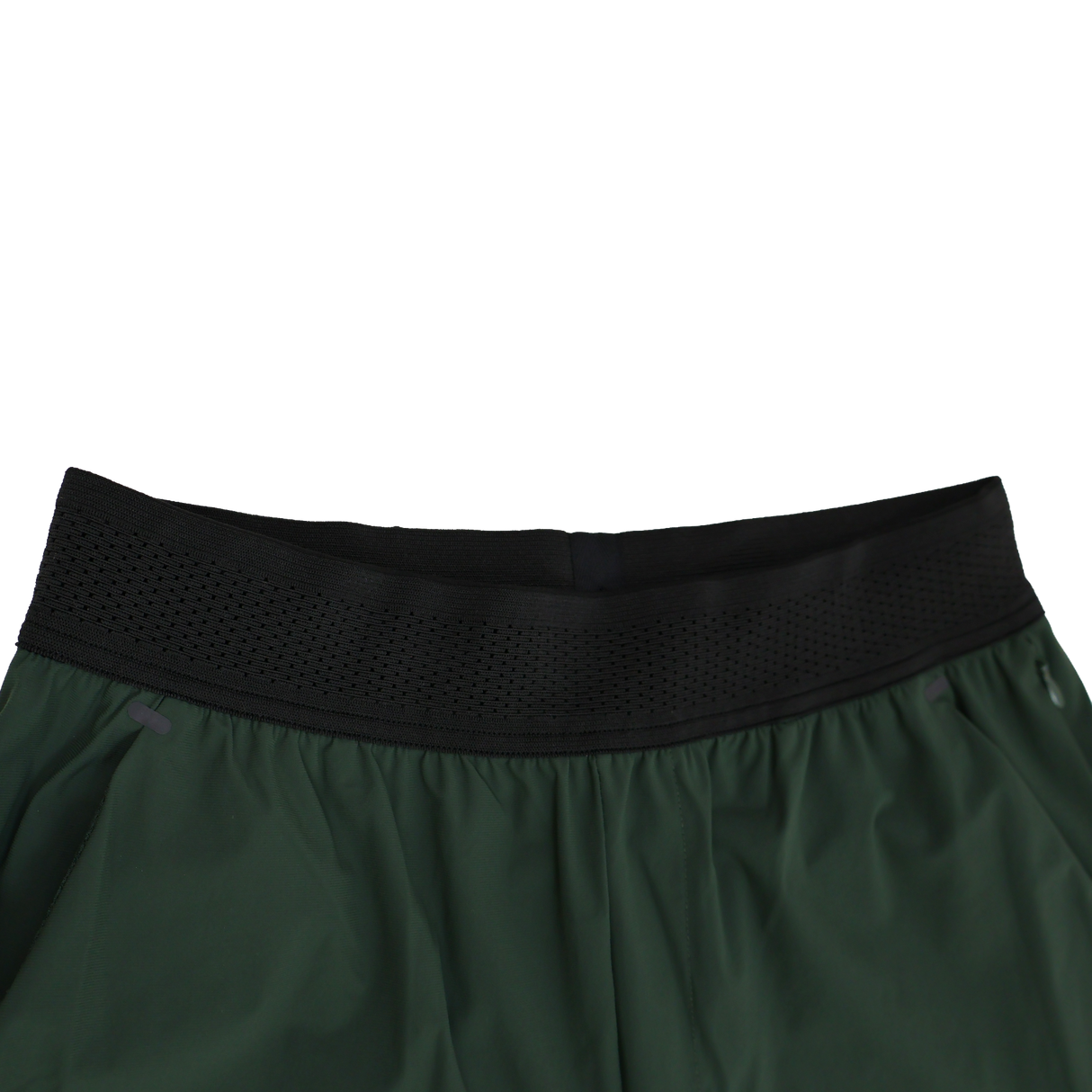 Close-up of the waistband on Canterbury Everest Woven Pant 30" by Canterbury, featuring a black perforated elastic band with sweat-wicking and four-way stretch properties, shown against a white background.