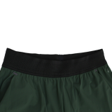 Close-up of the waistband on Canterbury Everest Woven Pant 30" by Canterbury, featuring a black perforated elastic band with sweat-wicking and four-way stretch properties, shown against a white background.