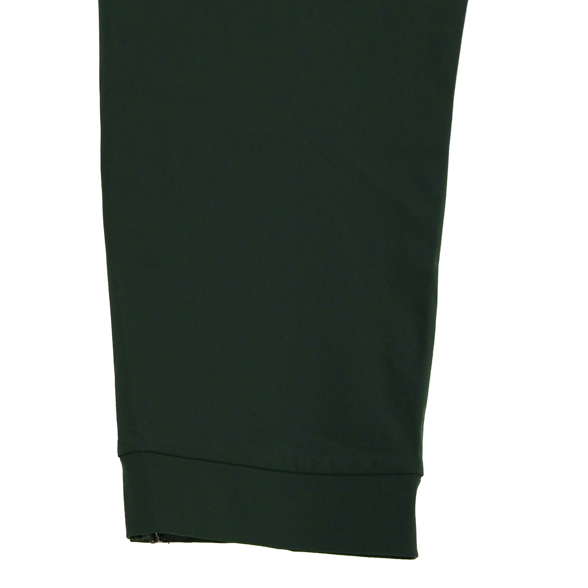 Close-up of the Canterbury Everest Woven Pant 30" in dark green by Canterbury, showing its cuffed hem and four-way stretch fabric, set against a plain white background.