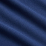 Close-up of blue fabric with visible diagonal folds and fine texture, highlighting the weave and subtle shading—characteristic of an athletic casual wear piece such as the Canterbury Fundamentals T-shirt by Canterbury.