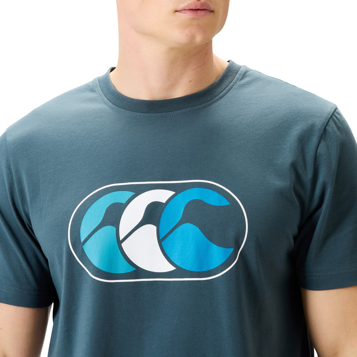 Wearing Canterbury's FUN. T-SHIRT AM—a blue crew-neck with stylized ocean waves—captures the laid-back Canterbury vibe.